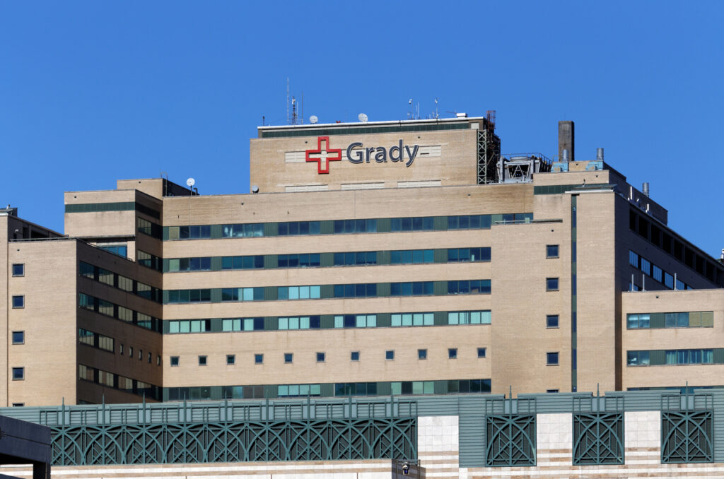 A photo of the Grady Memorial main hospital building with clear blue skies.