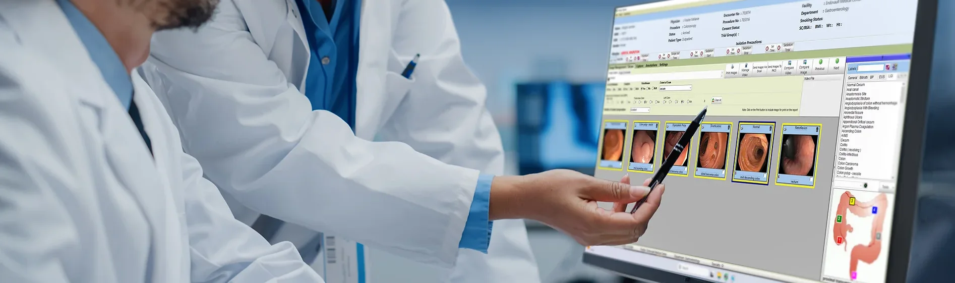 Two medical professionals analyzing the image capture & management screen within endovault.