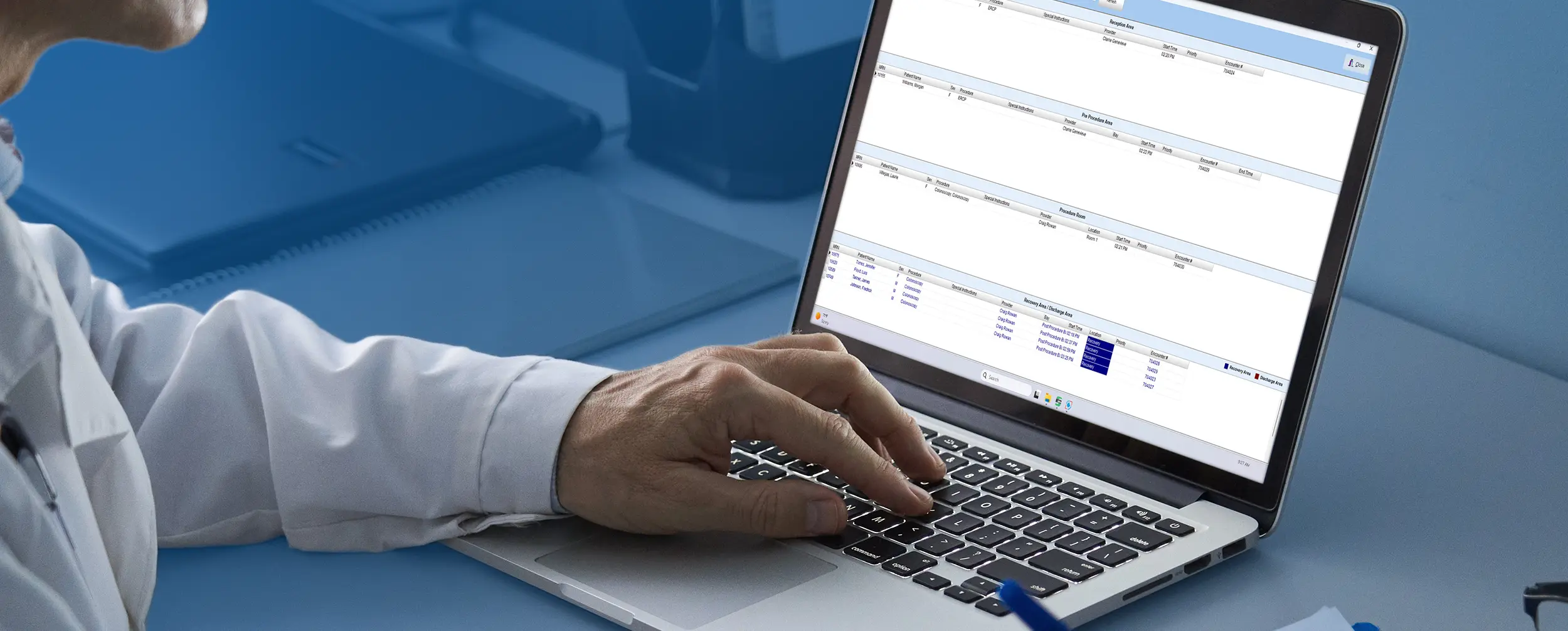 Man looking at a laptop with his hand on the keyboard, the screen shows EndoVault Patient tracking screen