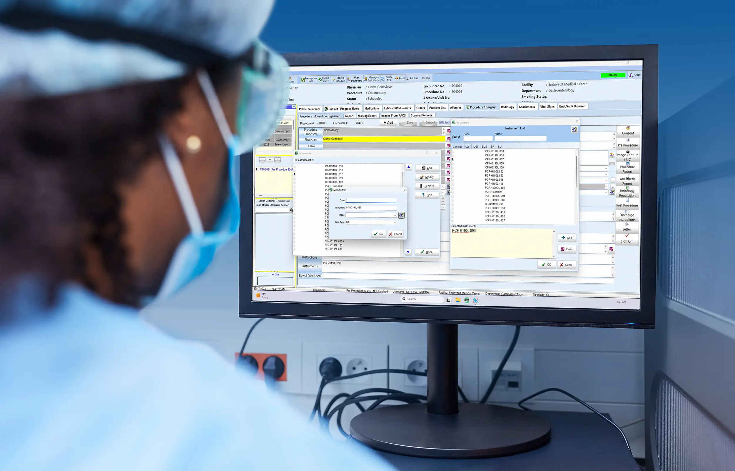 Female nurse with personal protection equipment looking at a screen that shows the EndoVault scope tracking screen